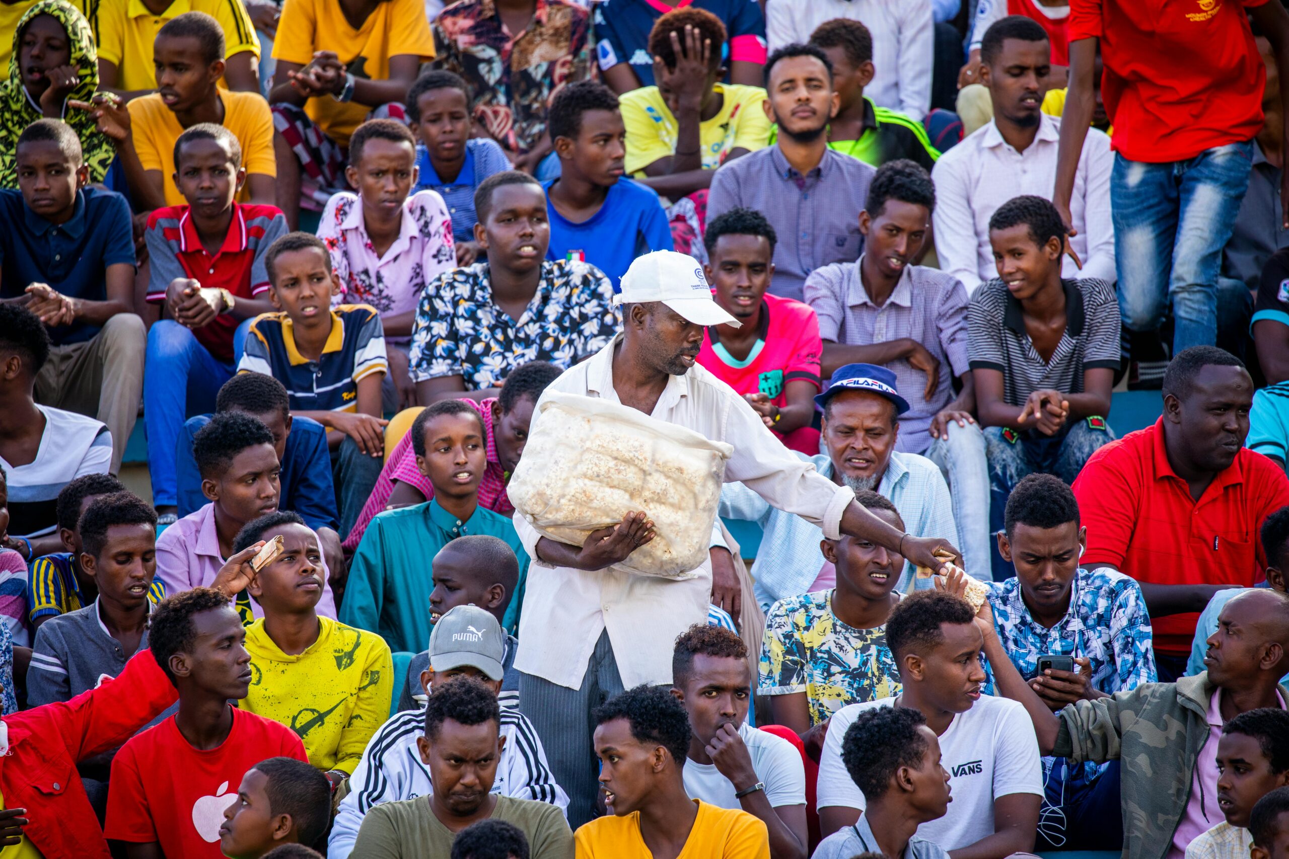 Engaged crowd in Mogadishu stadium, capturing lively audience interaction.